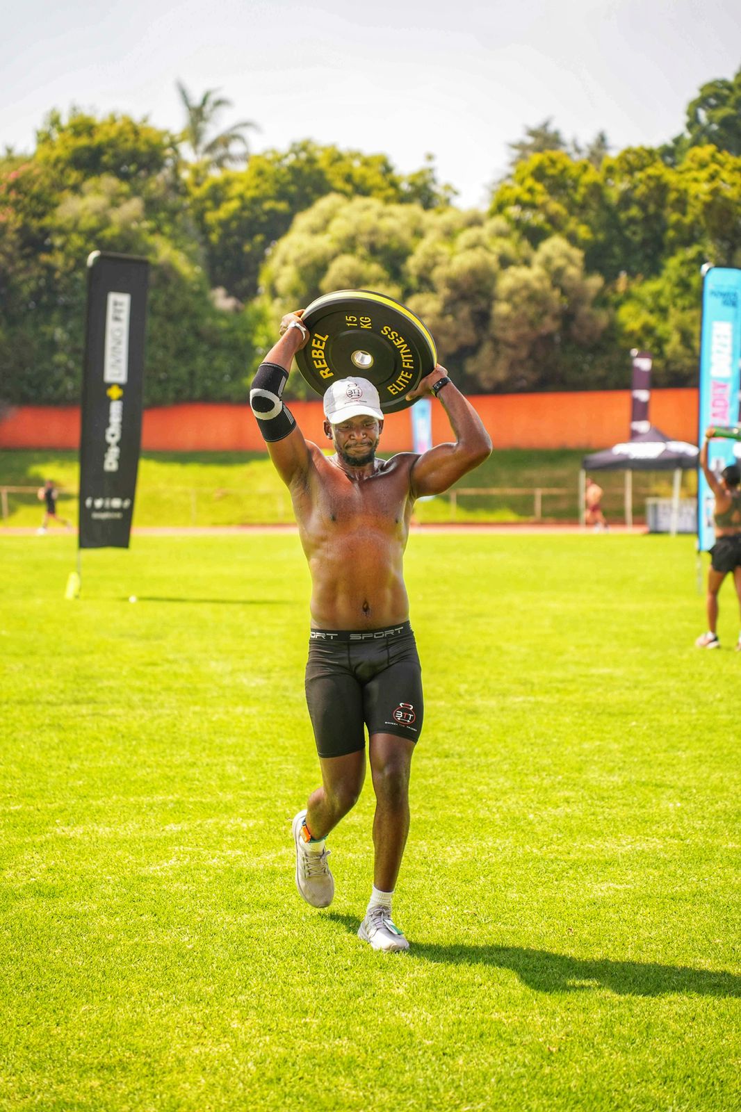 Bongza running with a weight plate overhead, African Championship